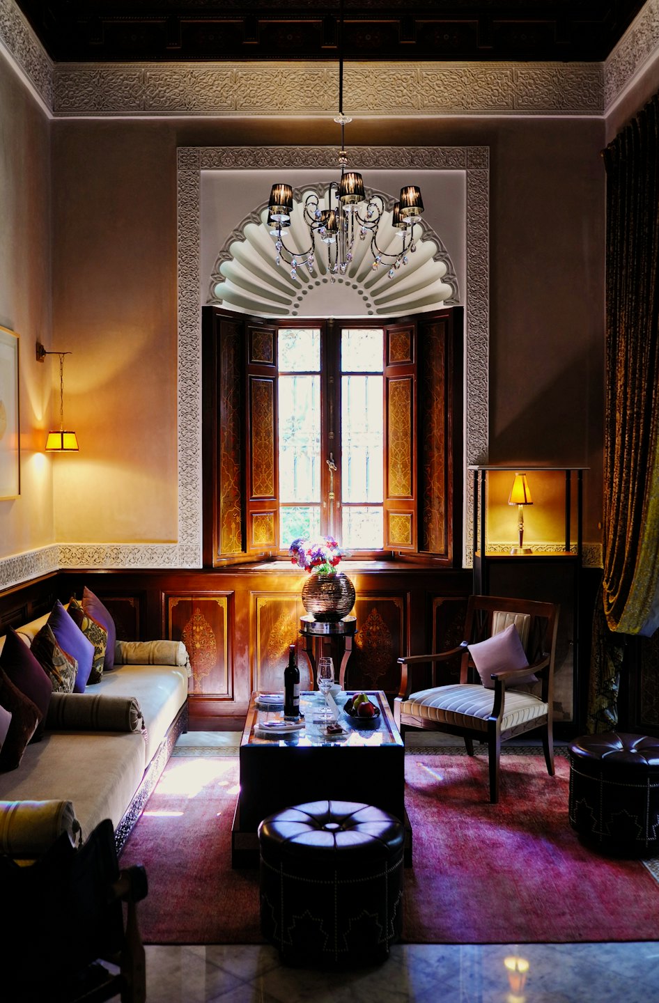 Traditional Moroccan room with plush seating and a fruit platter.
