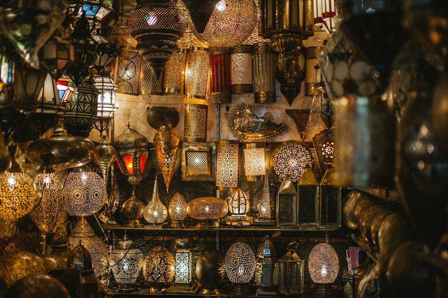 Moroccan lanterns glow warmly on a market stall.